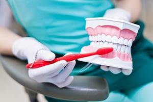 Dental hygienist demonstrating how to brush teeth
