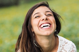 Woman smiling after dental crown restoration