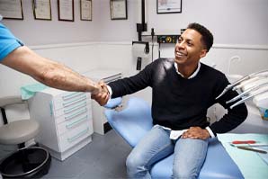 Dentist and patient discussing the cost of dental emergencies in Belmont