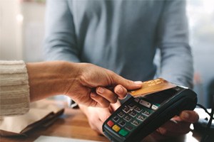 Patient using card to pay for dental service
