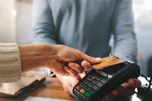 Patient using card to pay for dental service