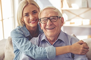 Senior man with adult daughter, both potential candidates for dental implants