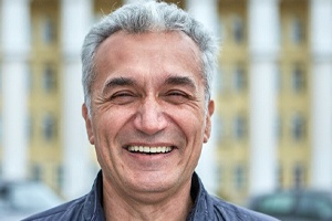 Smiling middle-aged man after successful recovery from dental implant surgery