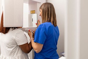 Dental team member setting up CBCT scan for patient