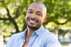 Man smiling after dental implant tooth replacement