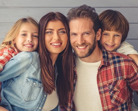 Family of four smiling