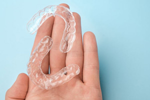 Two clear aligners resting on person’s hand