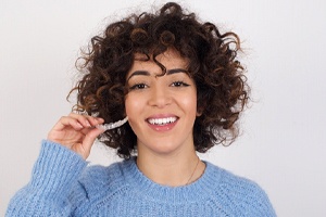 Smiling woman enjoying the many benefits of Invisalign