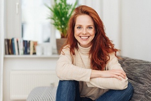 Smiling woman happy with her decision to opt for metal free restorations