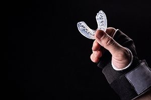 Hand holding scissors, ready to use them instead of teeth as tool