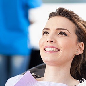 Smiling woman in dental chair for preventive dentistry