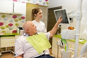 Dentist and senior patient discussing full mouth reconstruction