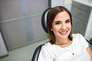 Happy female patient smiling after full mouth reconstruction