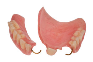 Broken partial denture in Belmont against blank, white background