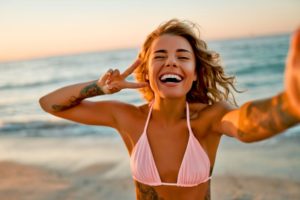 Woman on the beach, taking a selfie