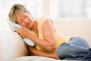 Woman resting at home on sofa