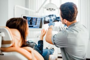 Dentist and patient looking at X-ray together 