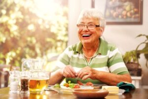 Happy senior eating a meal